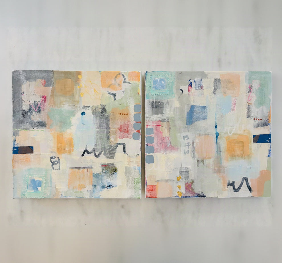 Two square abstract canvas paintings displayed side-by-side on a light marble surface. The artwork features a collage of pastel and neutral tones including beige, orange, blue, pink, gray, and white, with textured brushstrokes and abstract geometric shapes.