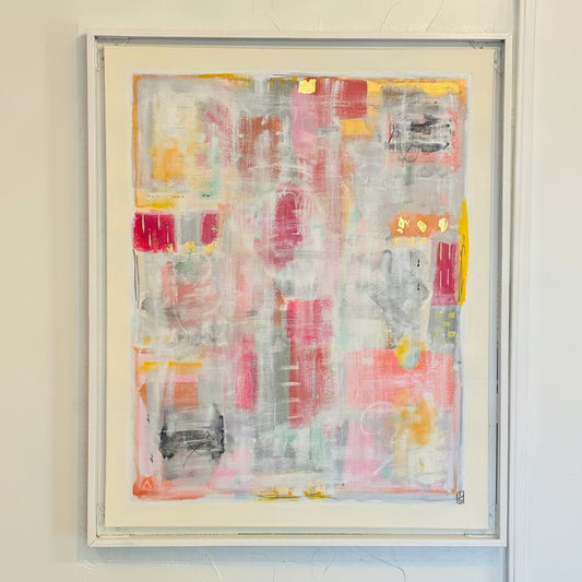An abstract framed painting featuring a textured collage of pink, gray, white, yellow, and red brushstrokes, mounted on a textured white wall.